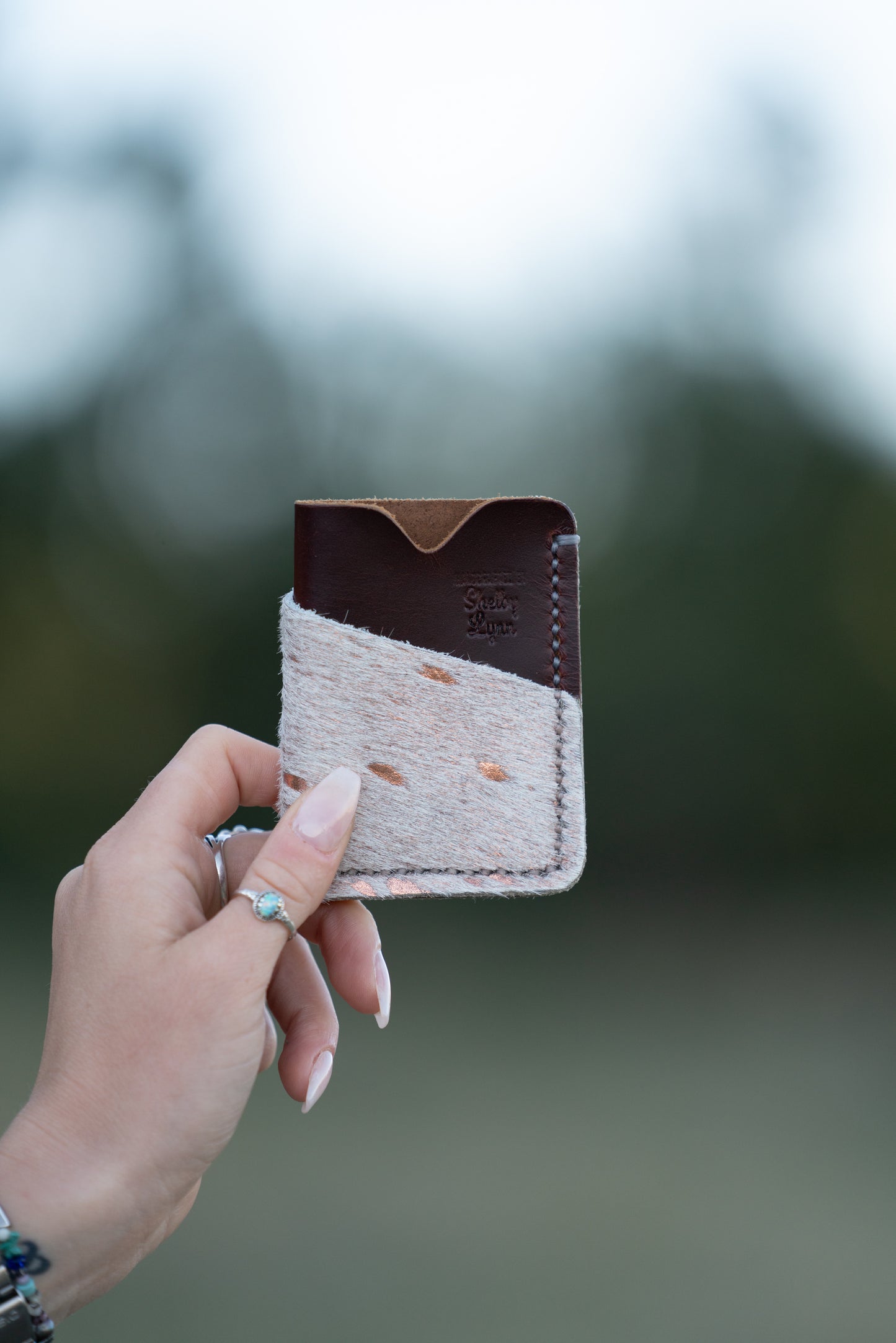 Redwood and Rose Gold Hair on Hide with White Stitching